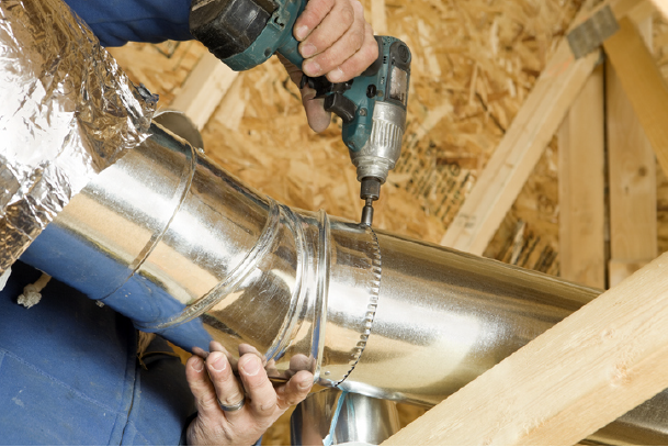 technician Installing an Attic Vent Duct | Advanced Heating and Air Conditioning